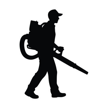 Silhouette of a worker using a leaf blower outdoors