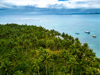 Daku Island, Siargao, Philippines. Tropical beach with palm trees and boats