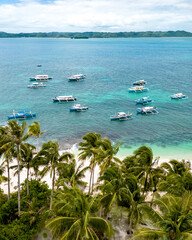 Daku Island, Siargao, Philippines. Tropical beach with palm trees and boats