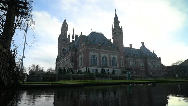 Reflection of a beautiful Peace Palace building and most visited building in The Hague and seat of the International Court of Justice at Autumn season