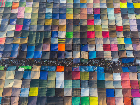 Aerial view of a vibrant patchwork of colorful tents and bustling crowds creates a captivating mosaic from above, Dhaka, Dhaka Division, Bangladesh.