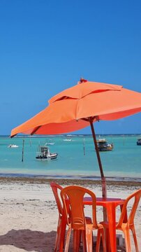 Beach umbrella with the turquoise blue sea in the background in Sao Jose da Coroa Grande, Pernambuco