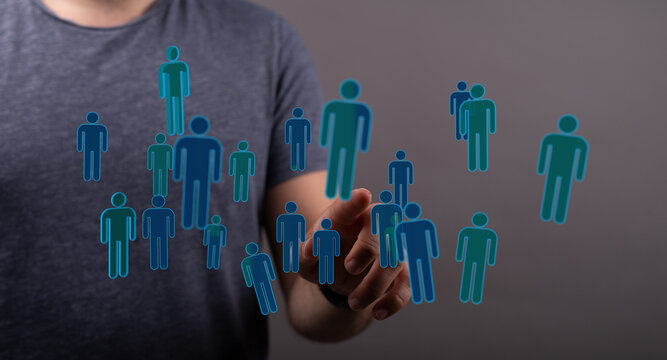 A person interacting with digital human icons, symbolizing teamwork, community, and social connections in a fut