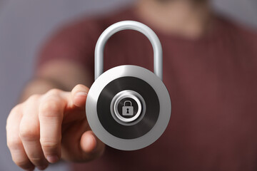 Closeup of hand pointing at a padlock, symbolizing digital security, data protection, and privacy in the online
