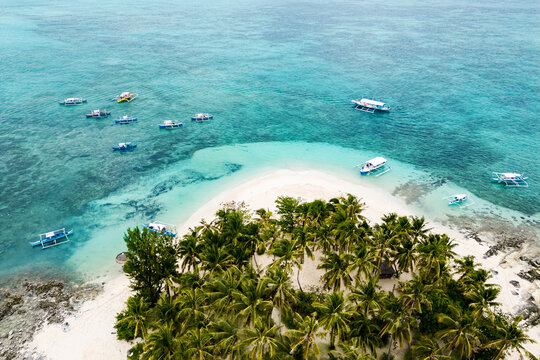Guyam Island, Siargao, Philippines. Tropical island with a turquoise ocean and boats