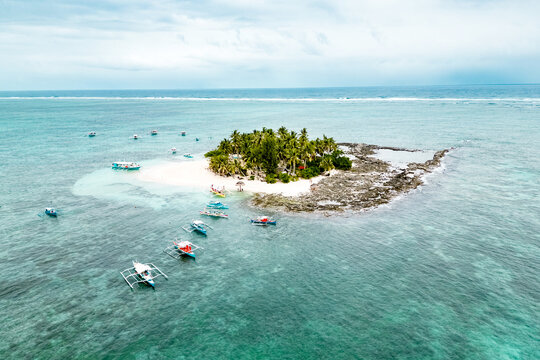 Guyam Island, Siargao, Philippines. Tropical island with a turquoise ocean and boats