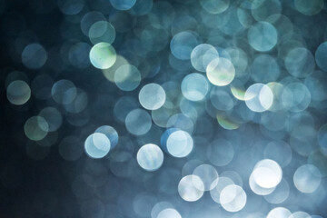 Soft focus image of bokeh effect over grass. the background at night time for overlay design, suitable for text and layout purposes