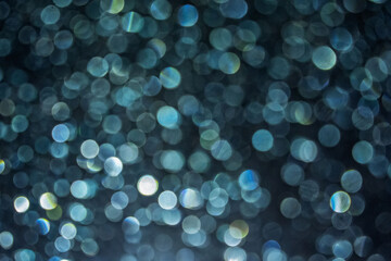 Soft focus image of bokeh effect over grass. the background at night time for overlay design, suitable for text and layout purposes