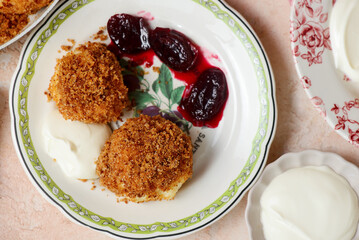 Traditional Austrian cottage cheese dumplings in breadcrumbs with plum compote and sour cream.