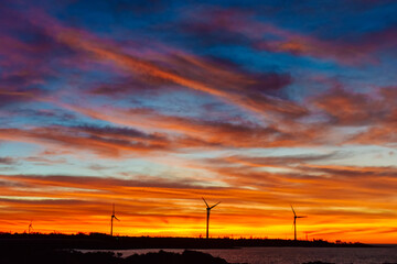 Sunset and Wind Turbine landscape over the Hainan Ring Expressway in Ledong County, Hainan, China, in autumn season