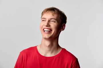 Smile, laughter, red shirt, happy, casual, young man, headshot, studio, joy accompany a bright lifestyle moment, presenting friendly energy and confident vibe for branding, social media and creative