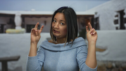 Young woman in urban street making gesture outdoors suggesting humor and surprise in city...
