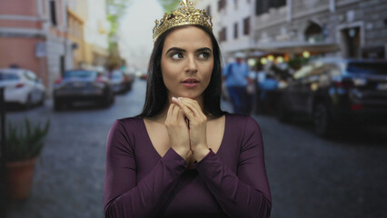 Young woman with crown stands on street with thoughtful expression and cars in background, embodying elegance and contemplation in an urban outdoor setting.