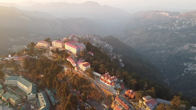 Beautiful drone view of the ridge shimla including christ church and people are walking on mall road shimla. Heavy traffic on shimla kufri highway and car are moving to kufri from shimla. 