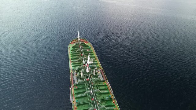 Drone Shot of Green Oil Tanker Ship Moving on Calm Dark Blue Ocean Water