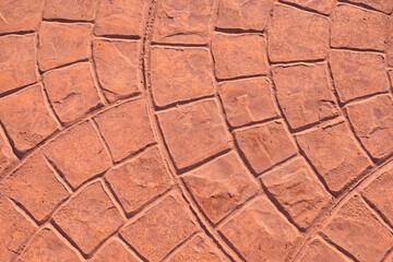 Textured stone pavement with intricate patterns and warm earthy tones