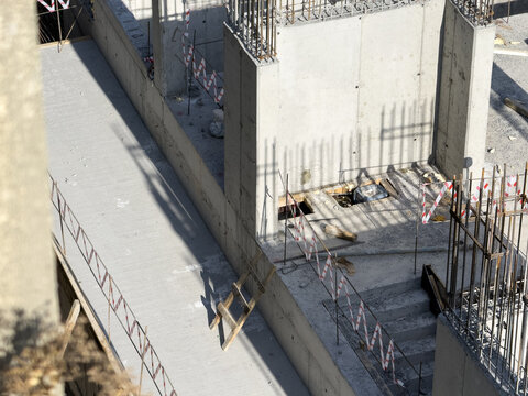 View of stark concrete pillars and unfinished surfaces cast sharp shadows on a construction site, a scene of urban development in progress, Istanbul, Istanbul, Turkey.