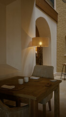 Cozy mediterranean restaurant interior with a wooden table set for two, featuring warm lighting, rustic decor, and a peaceful ambiance.