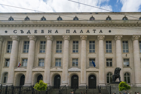 Sofia, Bulgaria - 06 May 2017: View of the Palace of Justice, a majestic building adorned with classical columns, stands proudly against a backdrop of soft blue skies and fluffy white clouds.