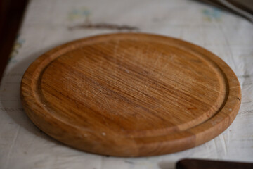 Close-up of an empty, rustic, used chopping board on a kitchen table