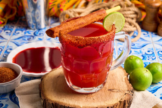 Homemade michelada cocktail with beer, lime juice, hot sauce, and tomato juice - Powered by Adobe