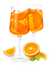 Glasses of refreshing spritzer cocktail and orange slices isolated on white