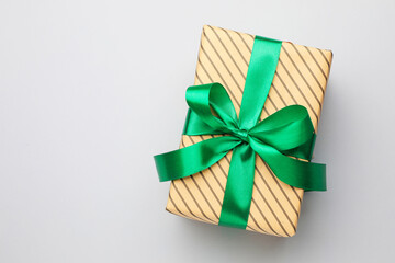 Beautiful wrapped gift on light background, top view. Space for text