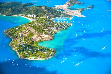 Aerial view of Queensland ocean and Whitsunday Islands from airplane with turquoise waters