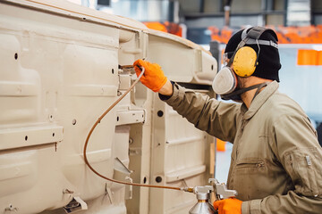 Professional anti corrosion undercoating treatment applied to hidden cavities of a car body. Long lasting metal protection and technical maintenance for extended vehicle lifespan.