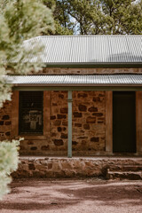 The building exterior of the old historic Wilpena Homestead house outdoor at daytime in the forest of Wilpena Pound during springtime season in the Australian outback in Flinders Ranges.