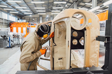 Professional anti corrosion undercoating treatment applied to hidden cavities of a car body. Long lasting metal protection and technical maintenance for extended vehicle lifespan.