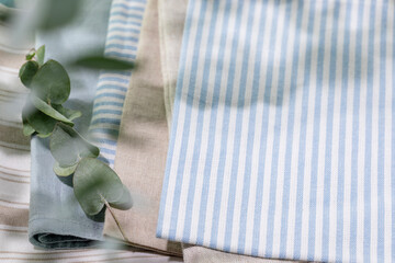 Striped Cotton Napkins On Linen Tablecloth With Eucalyptus Branch And Soft Natural Light. Perfect For Eco-Friendly Kitchen Designs, Home Decor Mockups, Or Sustainable Lifestyle Visual Content