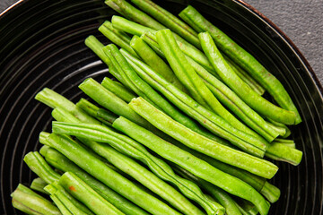 Green beans raw fresh vegetable string bean healthy food ingredient appetizer fresh tasty gourmet food background on the table rustic top view copy space keto and paleo diet vegetarian and vegan food