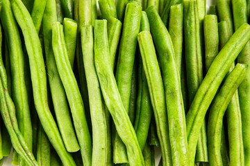 Green beans raw fresh vegetable string bean healthy food ingredient appetizer fresh tasty gourmet food background on the table rustic top view copy space keto and paleo diet vegetarian and vegan food