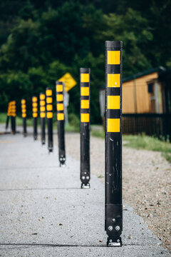 Flexible delineator posts with yellow reflective panels installed along a rural road near La Tuque in Quebec to guide traffic and improve safety.