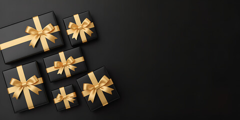 A collection of luxury black gift boxes with beautiful gold ribbons arranged on a dark surface