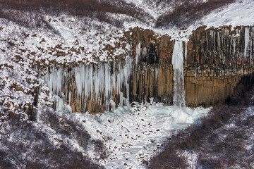 Frozen winter view of Sfartifoss waterfall, Iceland.