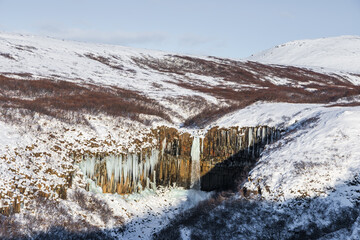 Frozen winter view of Sfartifoss waterfall, Iceland.