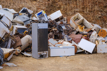 Abandoned and broken appliances in a junk yard setting