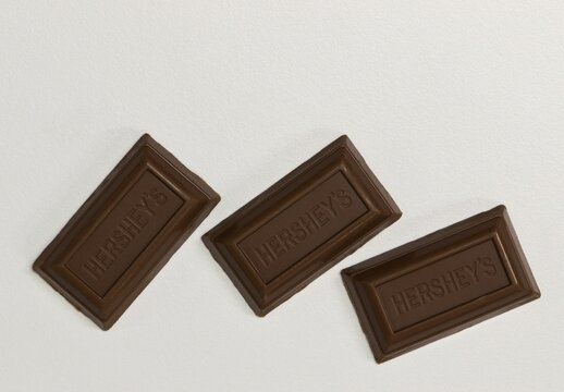  Hersheys zero sugar milk chocolate squares pieces scattered on white background copy space Houston, Texas USA 12-10-2025.