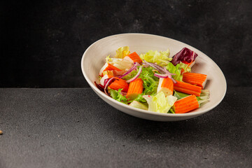 Crab sticks salad green salad leaves healthy food appetizer fresh gourmet food table setting rustic food top view copy space keto and paleo diet