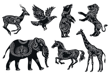 Fototapeta premium Animalistic floral silhouettes. Black fauna shapes with flowers patterns, boho style animals, ethnic oriental ornaments, wildlife elephant, horse and giraffe. Splendid vector cartoon flat set