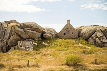 The famous 17th-century guardhouse stuck between two granite rocks, located in the old fishermen village of Meneham, Brittany, France. Front view