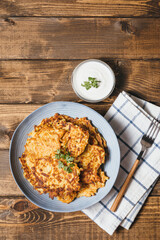 Potato pancakes Latkes on wooden table background. Traditional Jewish festive food for Hanukkah holiday. Jew festival of lights. Flat lay, top view