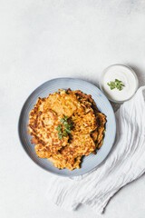 Potato pancakes Latkes on white table background. Traditional Jewish festive food for Hanukkah holiday. Jew festival of lights. Flat lay, top view