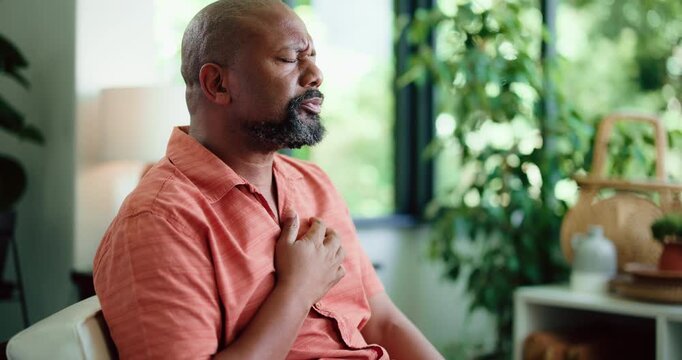 Sick, cough and black man in house with chest pain, infection or breathing problem in lung virus. Influenza, choking or mature person in home with tuberculosis, asthma or illness in allergy season.