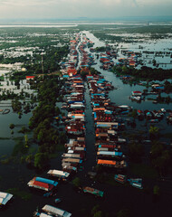 Kampong Phluk floating village with stilt houses on Tonle Sap lake in Cambodia.