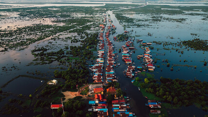 Kampong Phluk floating village with stilt houses on Tonle Sap lake in Cambodia.
