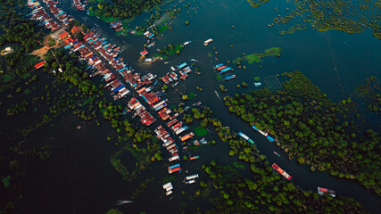 Kampong Phluk floating village with stilt houses on Tonle Sap lake in Cambodia.