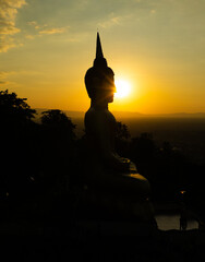 Aerial view at sunset above the Mekong river in Laos revealing Pakse city golden giant buddha